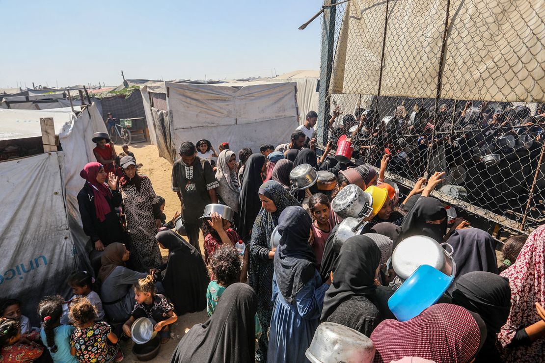 Palestinians gather to receive food on July 3, 2025, in Khan Younis, Gaza.