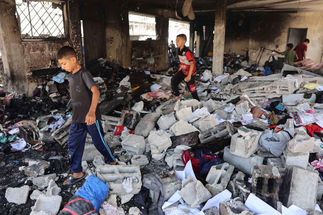 Children walk on debris at Mustafa Hafez school, which was sheltering displaced Palestinians, following an overnight Israeli strike in Gaza City on July 3.