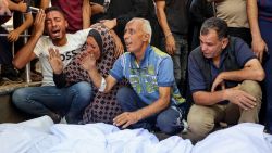 People mourn over the bodies of victims of an Israeli strike which hit the Mustafa Hafez school, sheltering Palestinians displaced by the war, before a funeral procession at al-Shifa hospital in Gaza City, on July 3, 2025, amid the ongoing conflict between Israel and the Palestinian Hamas militant group. (Photo by Omar AL-QATTAA / AFP) (Photo by OMAR AL-QATTAA/AFP via Getty Images)          