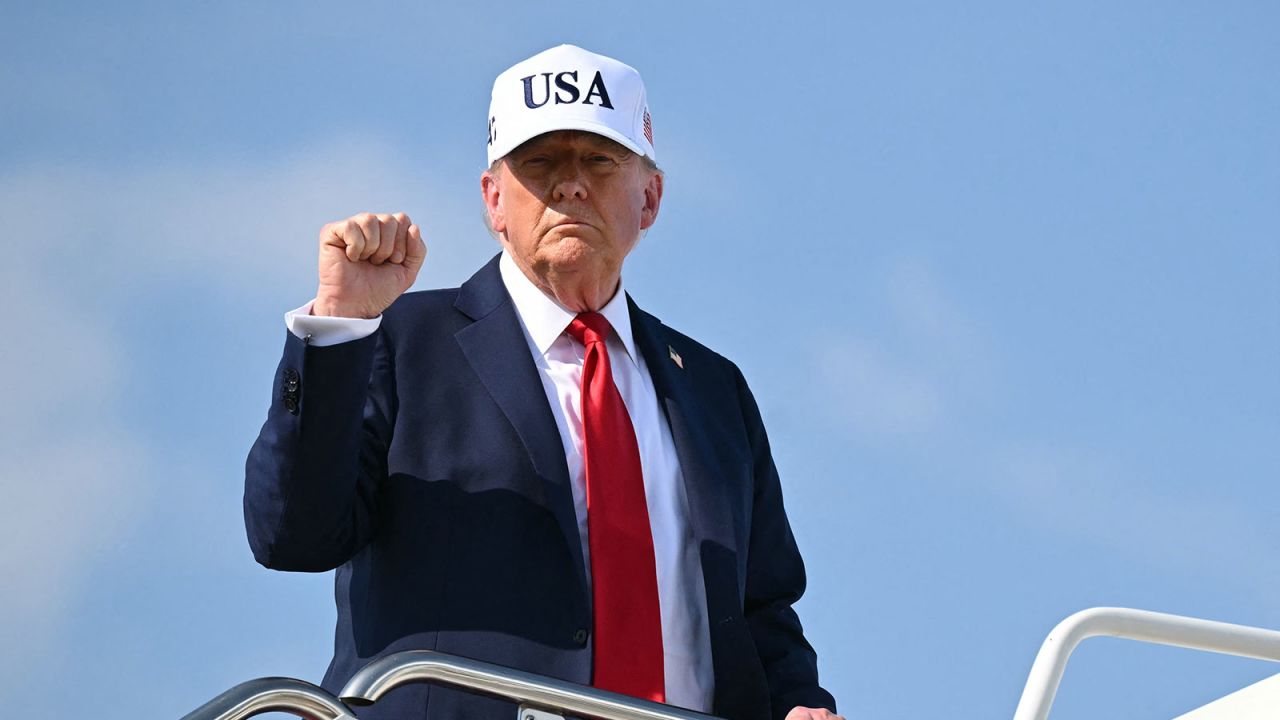 US President Donald Trump pumps his fist while boarding Air Force One at Joint Base Andrews in Maryland as he departs to deliver remarks at a Salute to America Celebration at the Iowa State Fairgrounds in Des Moines on July 3, 2025. (Photo by ANDREW CABALLERO-REYNOLDS / AFP) (Photo by ANDREW CABALLERO-REYNOLDS/AFP via Getty Images)          