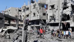 Palestinians inspect the damage after an Israeli strike in the Al-Bureij camp in central Gaza on July 4.