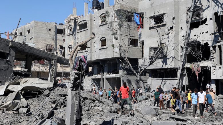 Palestinians inspect the damage after an Israeli strike in the Al-Bureij camp in central Gaza on July 4.