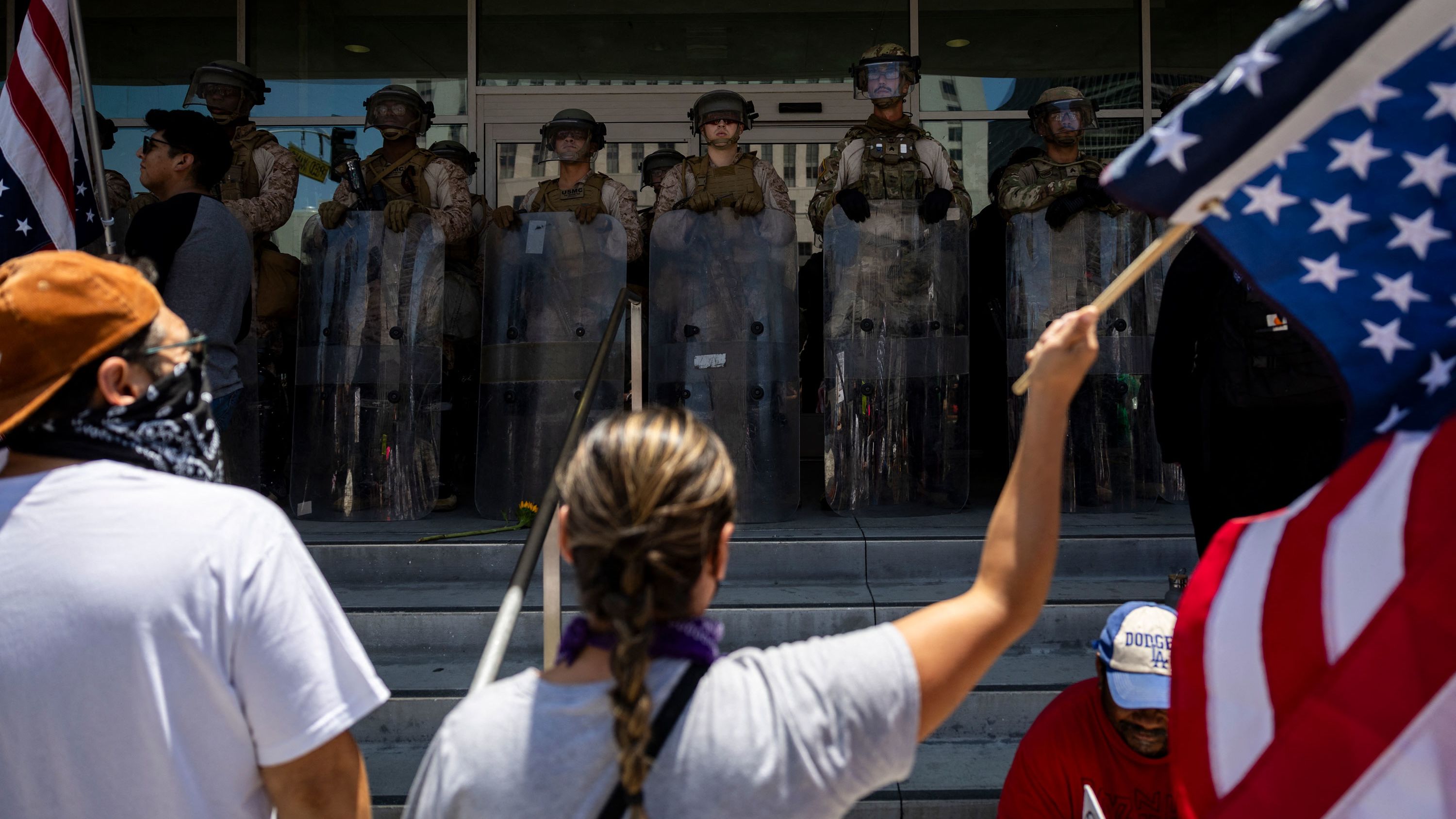 Demonstrators gather in front of the Federal building guarded by a mix of US marines and National guards during the "No Kings" protest following federal immigration operations, in Los Angeles, California on July 4, 2025. According to Immigration and Customs Enforcement (ICE) figures obtained by the Deportation Data Project, which collects US immigration enforcement data, 722 migrants were arrested in Los Angeles and the surrounding area from June 1 to 10. (Photo by ETIENNE LAURENT / AFP) (Photo by ETIENNE LAURENT/AFP via Getty Images)          