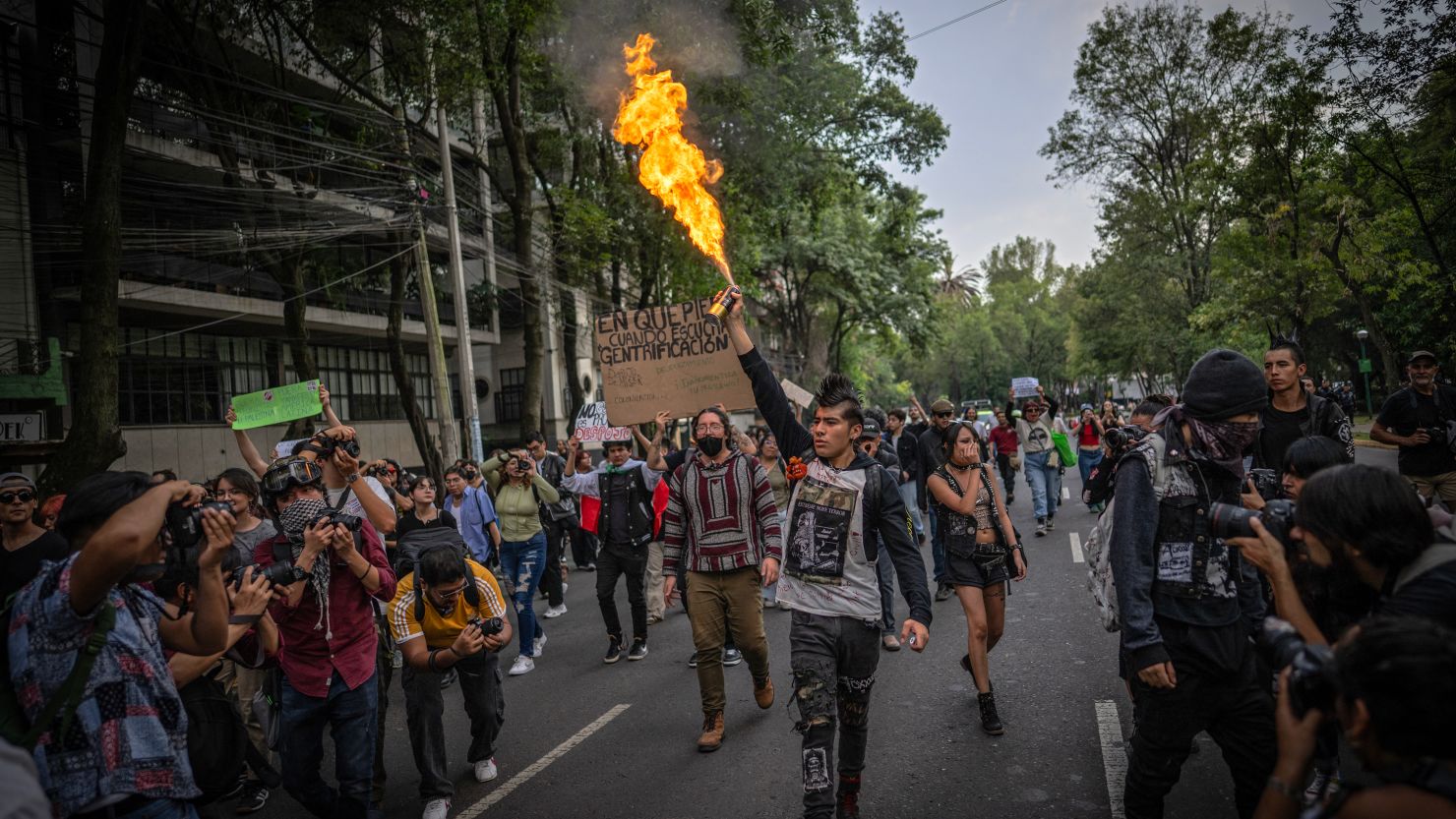 A protestor lights an aerosol can during a protest against gentrification in Mexico City, on July 4.