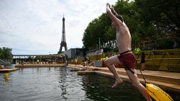 A swimmer jumps in the water at the Grenelle safe bathing site on Saturday.