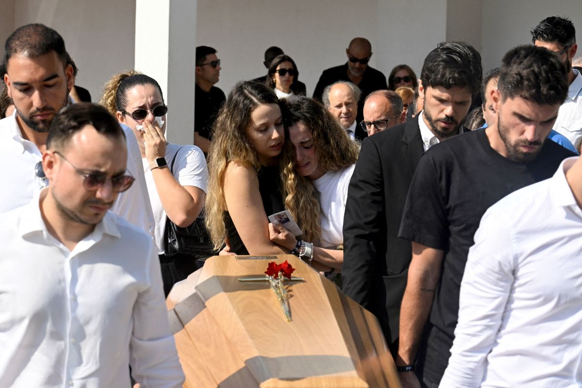 Jota's wife Rute Cardoso, center right, and her sister hold each other as former teammates carry Jota's and his brother André Silva's coffins, during their funeral in Gondomar, Portugal, on Saturday.