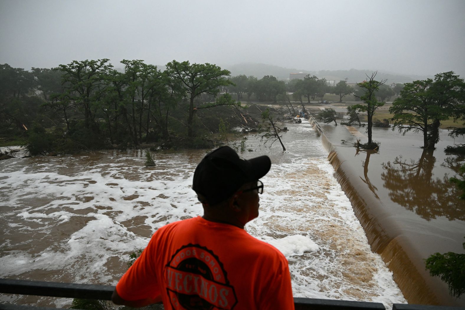 A person looks out at flooding in Kerrville, Texas.