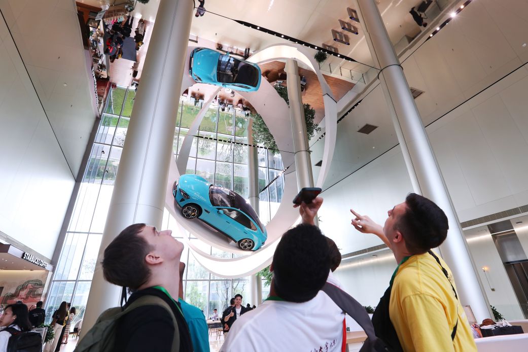 Foreign students visit Xiaomi Auto Super Factory on June 30, 2025 in Beijing, China.