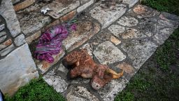 A plush toy sits on the ground outside of a cabin at Camp Mystic, the site of where at least 20 girls went missing after flash flooding in Hunt, Texas, on July 5, 2025. Rescuers were on Saturday searching for more than 20 girls missing from a riverside summer camp in the US state of Texas, after torrential rains caused devastating flooding that killed at least 27 people -- with more rain on the way. "So far, we've evacuated over 850 uninjured people, eight injured people and have recovered 27 deceased fatalities at this time. Of these 27, 18 are adults, nine are children," said Kerr Country Sheriff Larry Leitha on July 5. (Photo by RONALDO SCHEMIDT / AFP) (Photo by RONALDO SCHEMIDT/AFP via Getty Images)          