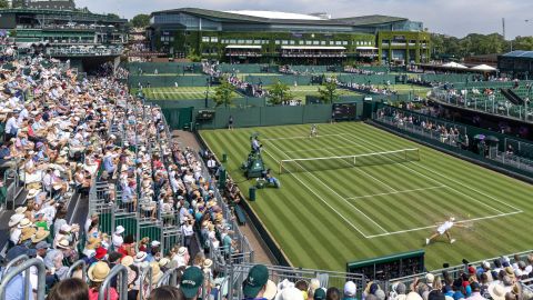 LONDON, ENGLAND - JULY 01: A general panoramic view of Wimbledon packed with spectators, with a back-drop of Centre Court, as Clara Tauson of Denmark plays against Heather Watson of Great Britain in the first round of the Ladies' Singles Competition on No.12 Court during the Wimbledon Lawn Tennis Championships at the All England Lawn Tennis and Croquet Club at Wimbledon on July 1st, 2025, in London, England. (Photo by Tim Clayton/Getty Images)