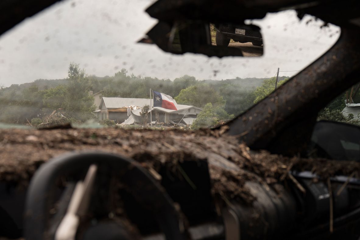 A Texas flag is seen through the remnants of a destroyed vehicle near Hunt on Saturday.