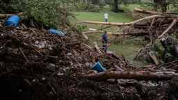 Two men search for survivors after flash flooding on the bank of the Guadalupe River in Center Point, Texas.