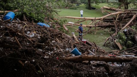 Two men search for survivors after flash flooding on the bank of the Guadalupe River in Center Point, Texas.