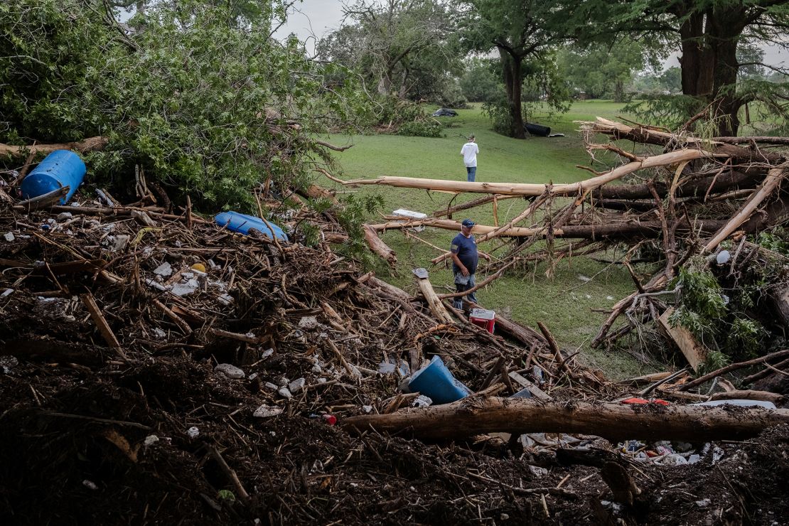Two men search for survivors after flash flooding on the bank Guadalupe River on July 5 in Center Point, Texas.