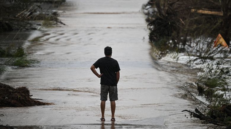 A man looks at a damaged road after severe flash flooding that occured during the July 4 holiday weekend, in Hunt, Texas, on July 6, 2025.