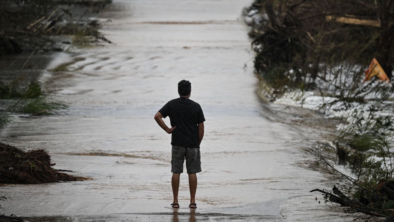 A man looks at a damaged road after severe flash flooding that occured during the July 4 holiday weekend, in Hunt, Texas, on July 6, 2025.