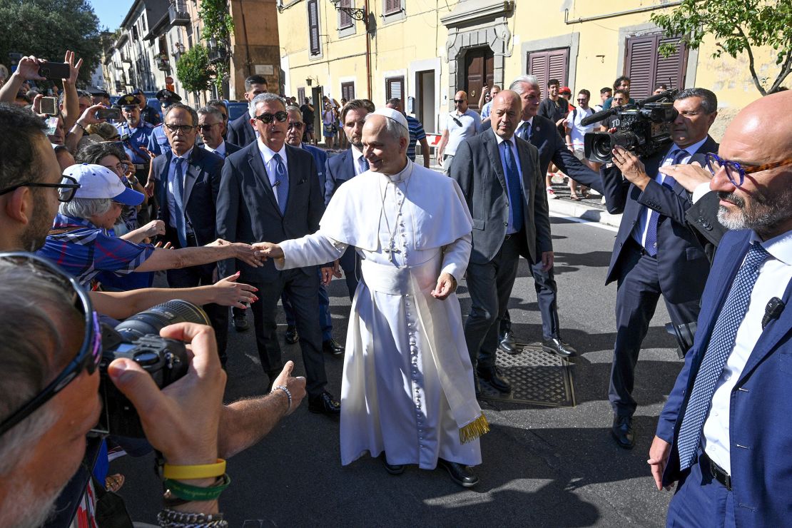 Pope Leo XIV greets people as he arrives for his two-week stay in Castel Gandolfo on Sunday.
