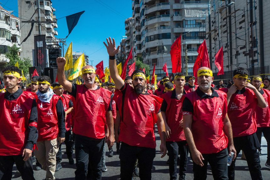 Worshipers of Shiite Islam, Lebanon's largest sect, gather in the capital Beirut on July 6 to celebrate the holy day of Ashura, flying Hezbollah flags.
