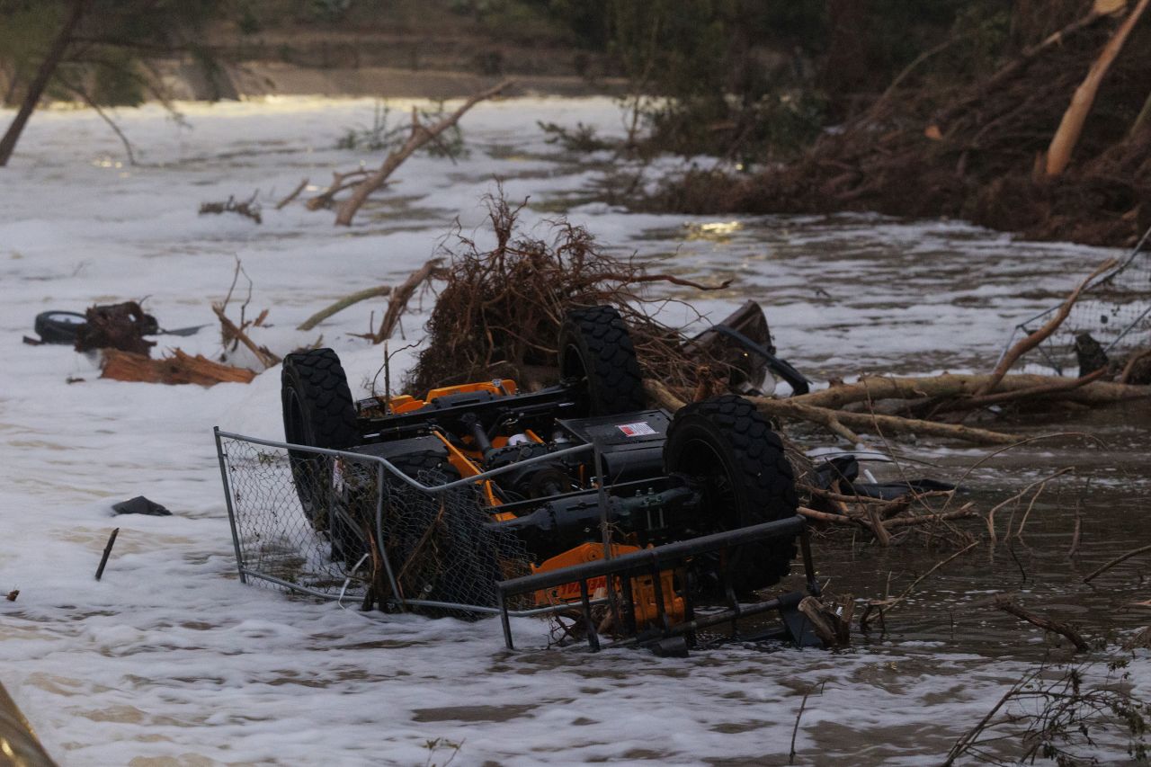 A vehicle is seen caught in the Guadalupe River in Kerrville, Texas, on Sunday.
