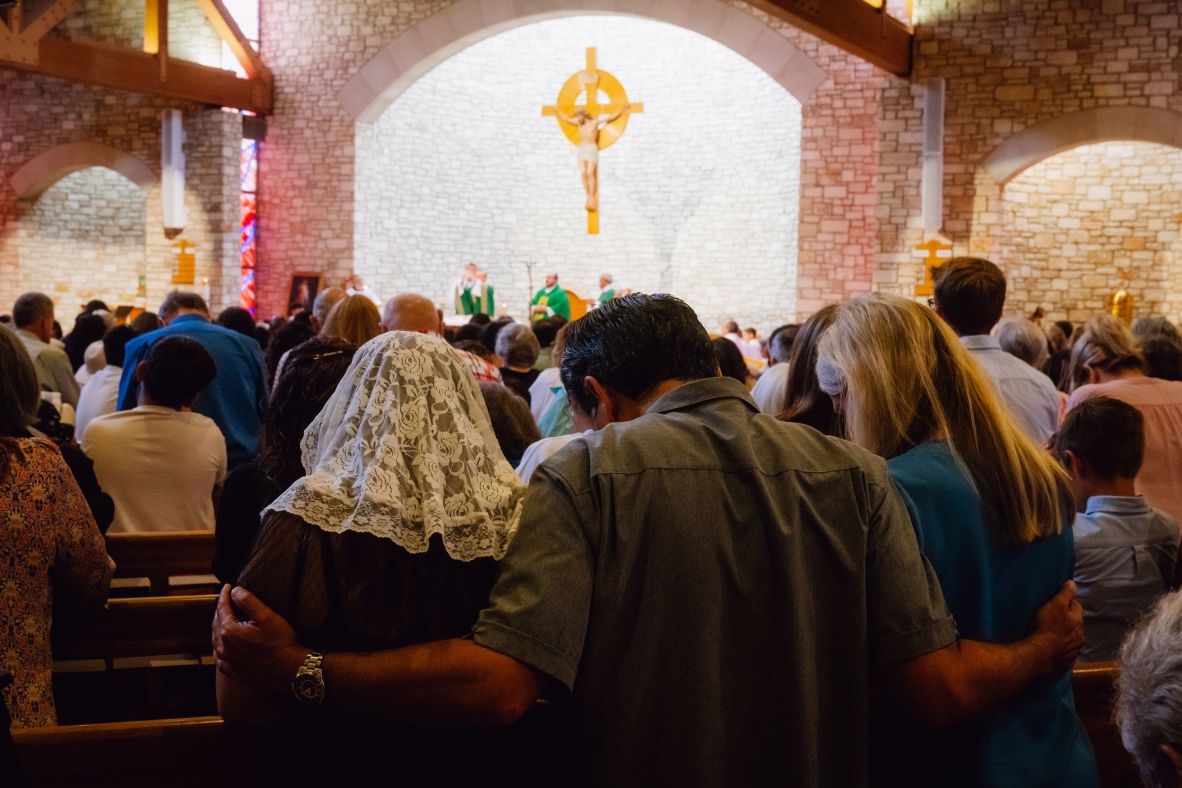 Community members pray for those impacted by the floods at the Notre Dame Catholic Church in Kerrville on Sunday.