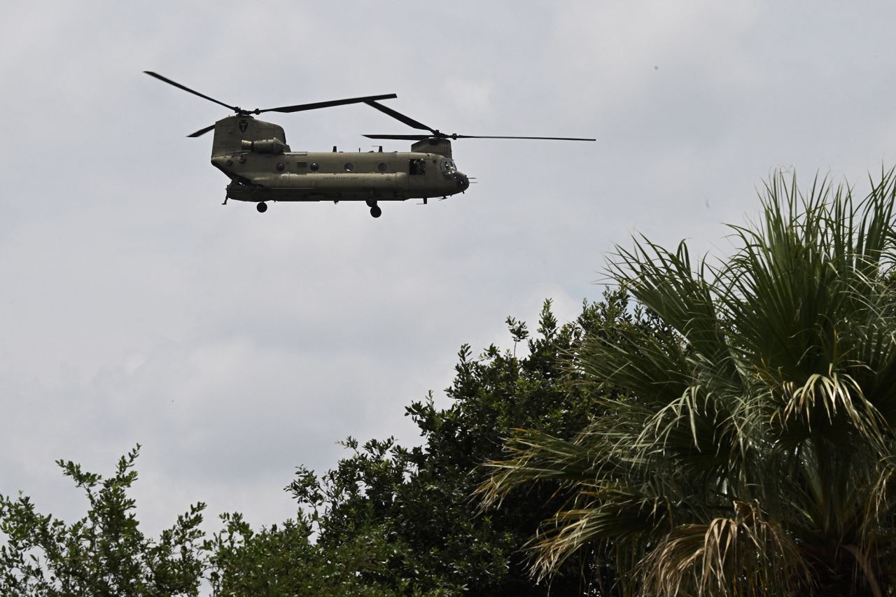 A helicopter flies overhead looking for missing people in Kerrville, Texas, on Monday.