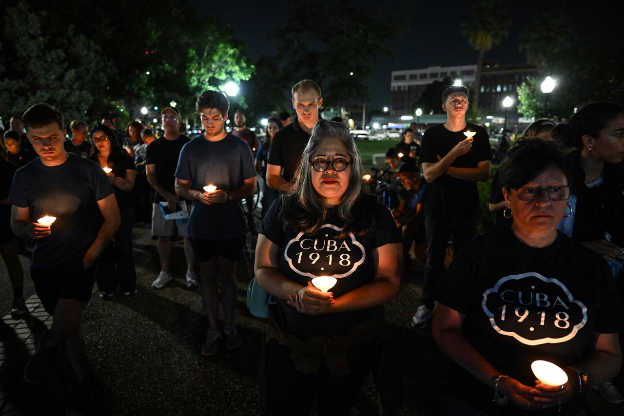 People hold candles as they take part in a vigil for the victims of the floods over Fourth of July weekend, at Travis Park, in San Antonio, Texas, on Monday.