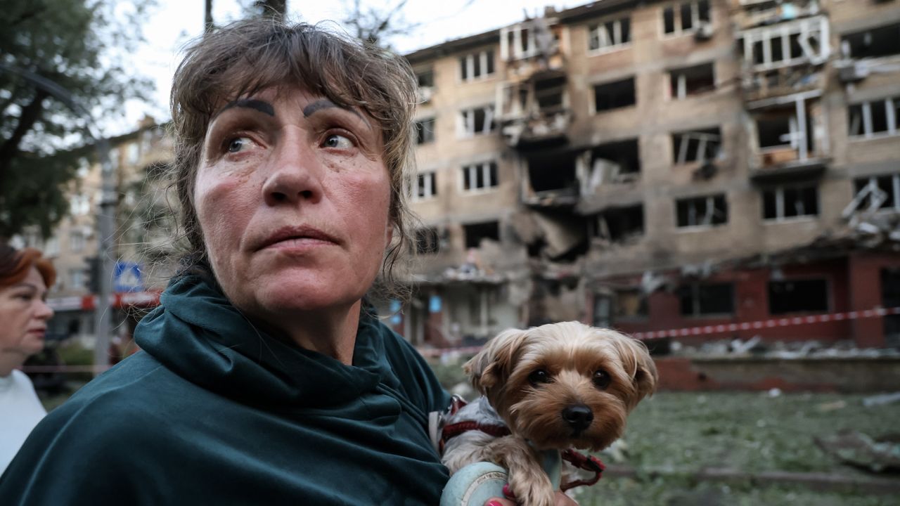 KYIV, UKRAINE - JULY 4: A woman with a small dog in her arms stands in the yard of a 5-story residential building in Solomyanskyi district heavily damaged by a Russian airstrike on July 4, 2025 in Kyiv, Ukraine. The Russian army launched a mass strike on Ukraine, using almost 540 drones and more than 10 missiles of various types, most of which were targeted at the Ukrainian capital - Kyiv, and Kyiv Oblast. Many people were injured in Kyiv. The attack resulted in damage to civilian infrastructure, residential buildings, and vehicles in six districts of Kyiv, with the Sviatoshynskyi and Solomyanskyi districts being the worst affected. The rail infrastructure was also damaged and requires restoration. (Photo by Ivan Antypenko/Suspilne Ukraine/JSC "UA:PBC"/Global Images Ukraine via Getty Images)
