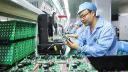 Employees work on a production line of electric car charging station at a factory in Ruichang, in central China's Jiangxi province on July 9, 2025.