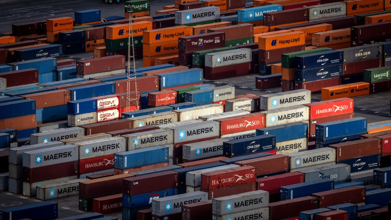 Stacked shipping containers in the commercial port of Barcelona, Spain, on Monday, July 7, 2025. The EU is said to be seeking a preliminary agreement with the US that would allow it to lock in a 10% tariff rate beyond an Aug. 1 deadline.