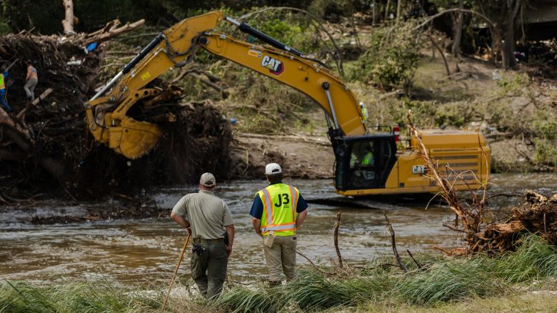 Search and recovery crews use a large excavator to remove debris from the bank of the Guadalupe River in Center Point, Texas, on Wednesday.