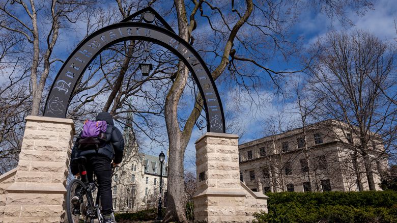 A bicyclist passes by the arch on the Northwestern University campus on March 31, in Evanston, Illinois. (