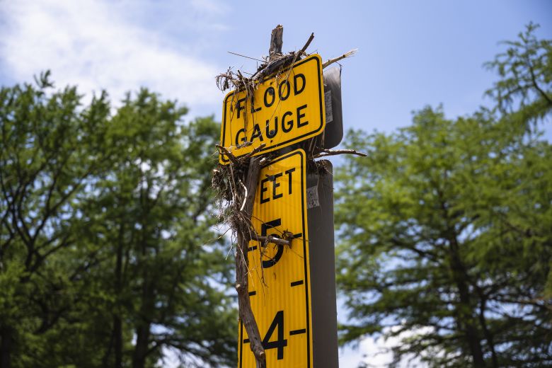 Debris sits on a flood gauge following flooding in Hunt, Texas, on July 9.