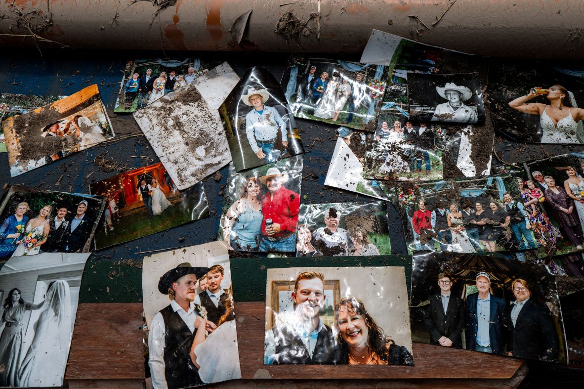 Salvaged photographs of the Rich family are displayed on a table in their home in Center Point, Texas, on Sunday.
