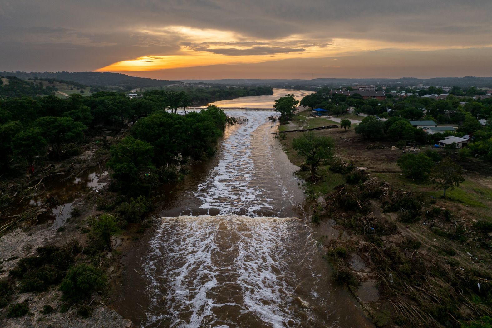 The sun sets over the Guadalupe River in Kerrville on Sunday.