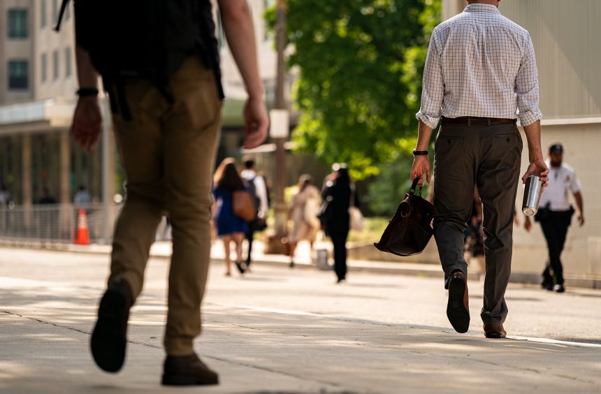 Workers arrive at the US State Department in Washington, DC, on July 11.