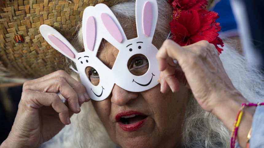 A woman wears a bunny rabbit mask before the start of the first show of Puerto Rican singer Bad Bunny's 30-date concert residency at the Coliseo de Puerto Rico in San Juan, Puerto Rico, on July 11, 2025. (Photo by Ricardo ARDUENGO / AFP) (Photo by RICARDO ARDUENGO/AFP via Getty Images)          