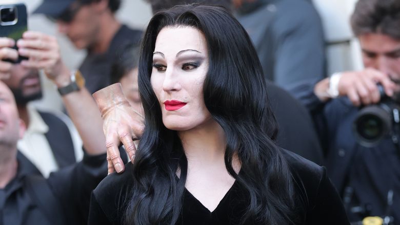 For his latest look, performance artist Alexis Stone transformed into Morticia Addams, the matriarch played by the actor Anjelica Huston in the 1990s "Addams Family" films.