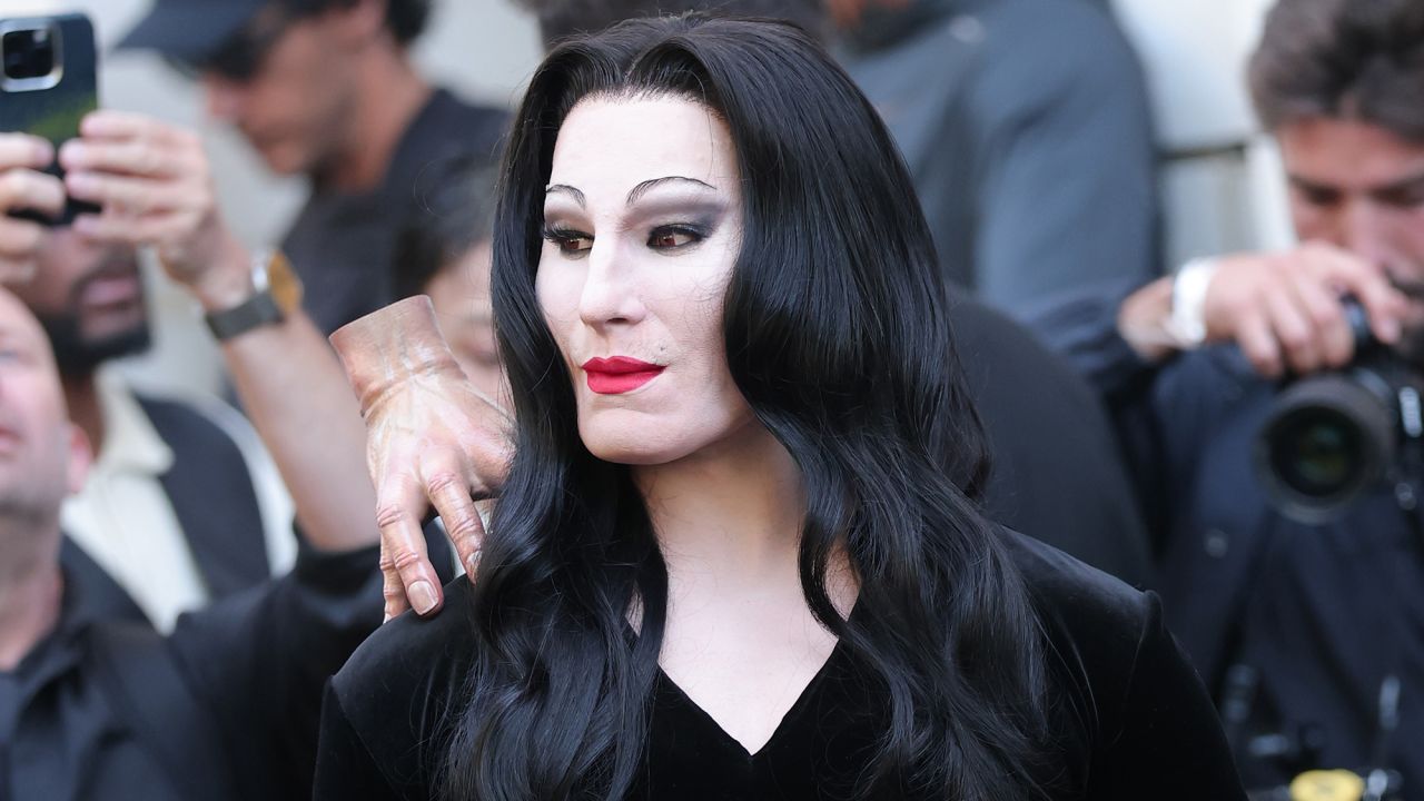 For his latest look, performance artist Alexis Stone transformed into Morticia Addams, the matriarch played by the actor Anjelica Huston in the 1990s "Addams Family" films.