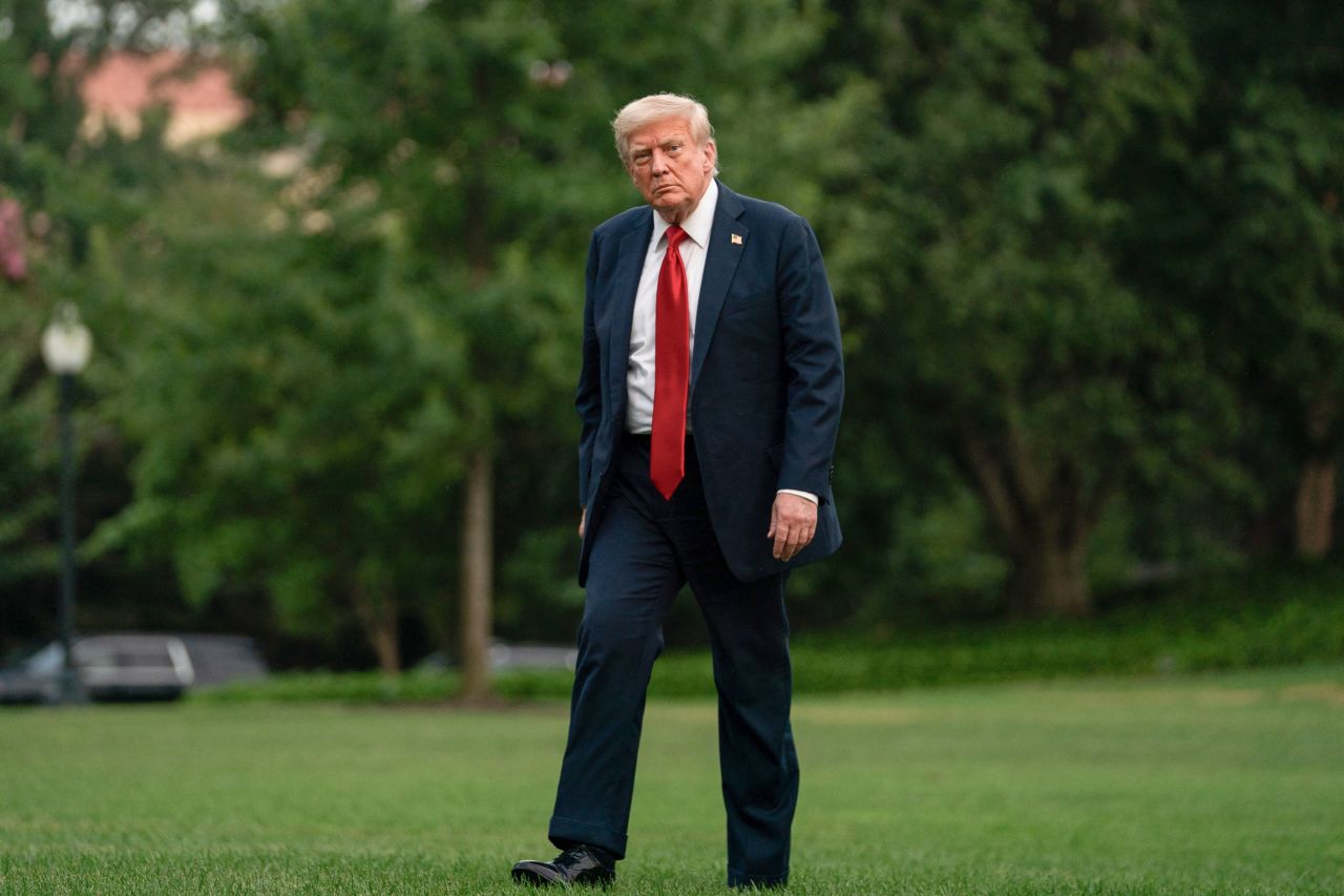 President Donald Trump walks on the South Lawn upon arrival at the White House in Washinton DC, on Sunday.