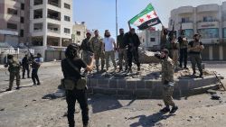 Syria's security forces pose for a picture on a roundabout in the predominantly Druze city of Sweida on July 15, 2025, following clashes between Bedouin tribes and Druze fighters. Syrian government forces entered the majority Druze city of Sweida on July 15, 2025, the interior ministry said, aiming to end clashes with Bedouin tribes that have killed nearly 100 people. (Photo by Sam HARIRI / AFP) (Photo by SAM HARIRI/AFP via Getty Images)