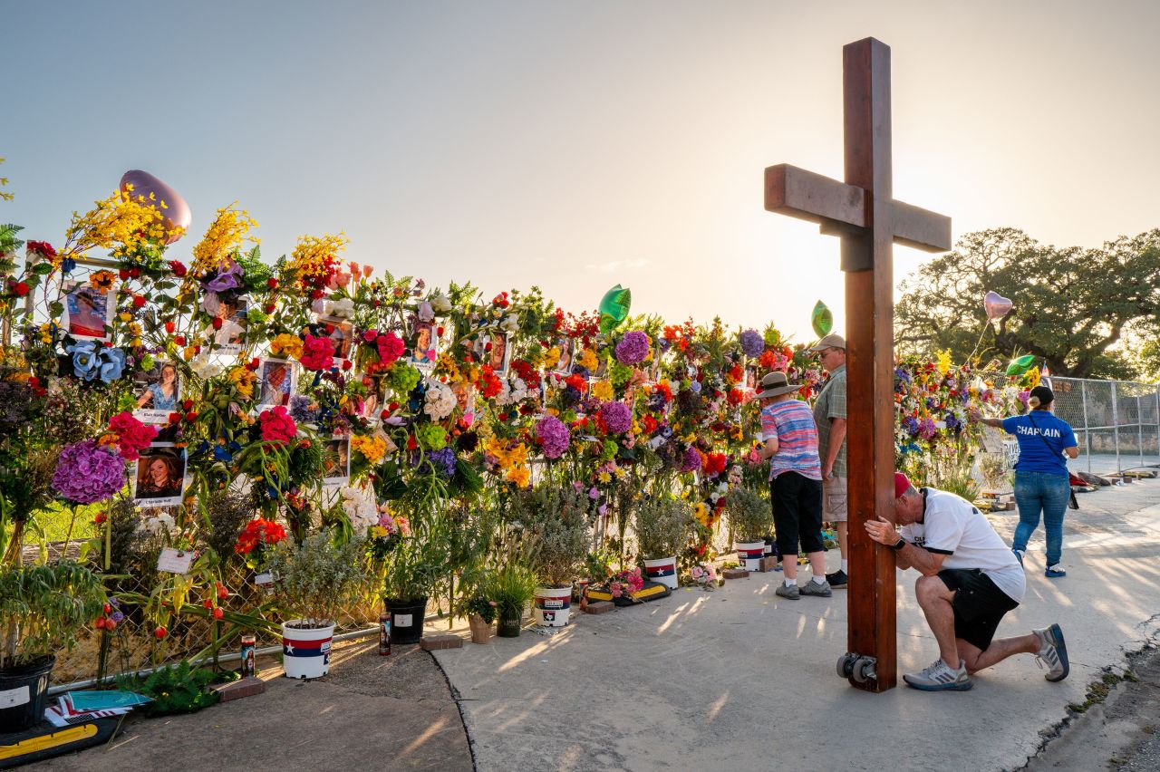People grieve and pay their respects at a memorial for flooding victims in Kerrville, Texas, on Thursday.