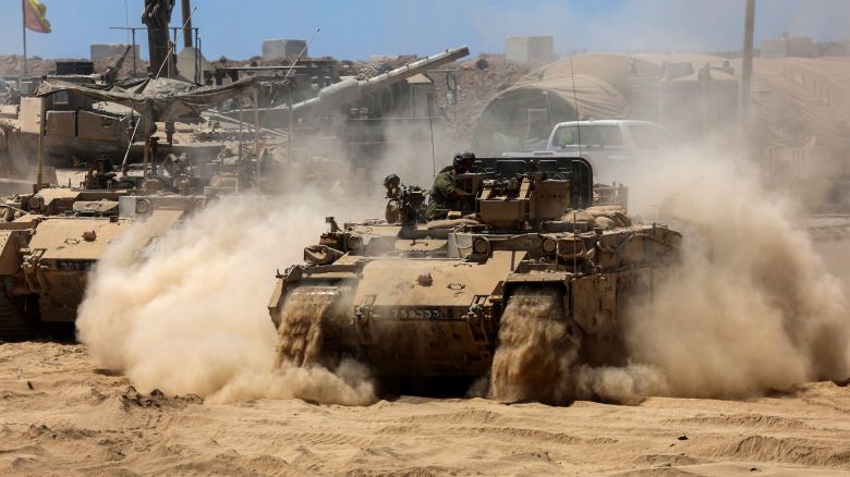 Israeli troops deploy tanks near the Gaza border on July 15.