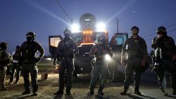 Federal agents block people protesting an ICE immigration raid at a nearby licensed cannabis farm on July 10, 2025 near Camarillo, California.