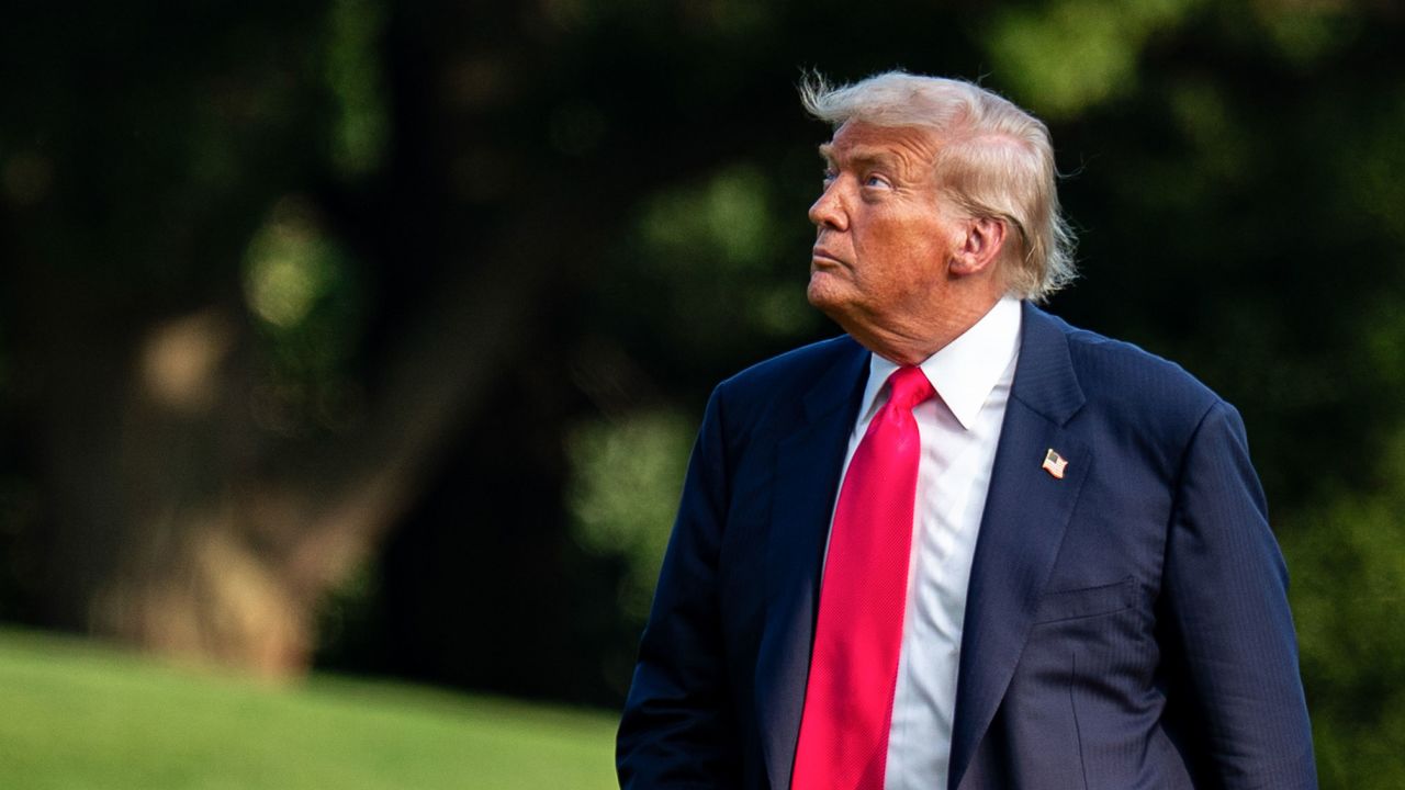 US President Donald Trump walks on the South Lawn of the White House in Washington, DC, on Tuesday after arriving on Marine One.