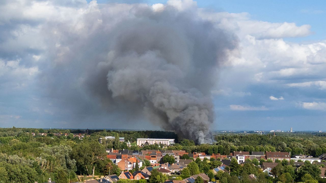 TOPSHOT - Smoke caused by a fire billows above the site of the Tomorrowland electronic music festival in Boom, northern Belgium on July 16, 2025. (Photo by Tom Goyvaerts / Belga / AFP) / Belgium OUT (Photo by TOM GOYVAERTS/Belga/AFP via Getty Images)          