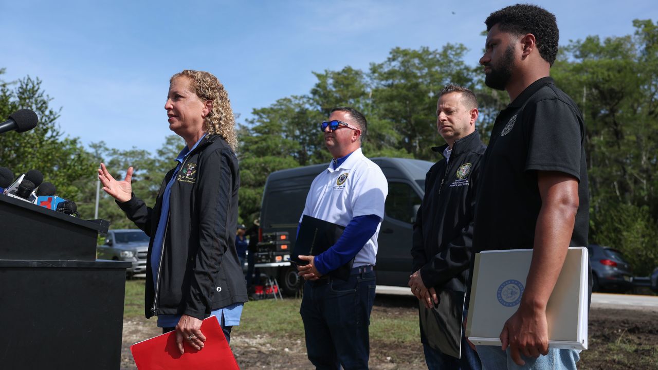 Rep. Debbie Wasserman Schultz, left, Rep. Darren Soto, Rep. Jared Moskowitz, second from right, and Rep. Maxwell Frost, right, speak to the media before visiting "Alligator Alcatraz" at the Dade-Collier Training and Transition Airport in Ochopee, Florida, on Saturday.