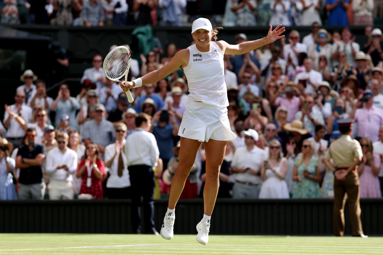 Iga Świątek celebrates after winning her first Wimbledon title.