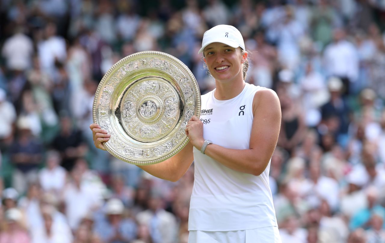 Świątek poses with the Venus Rosewater Dish after the match.
