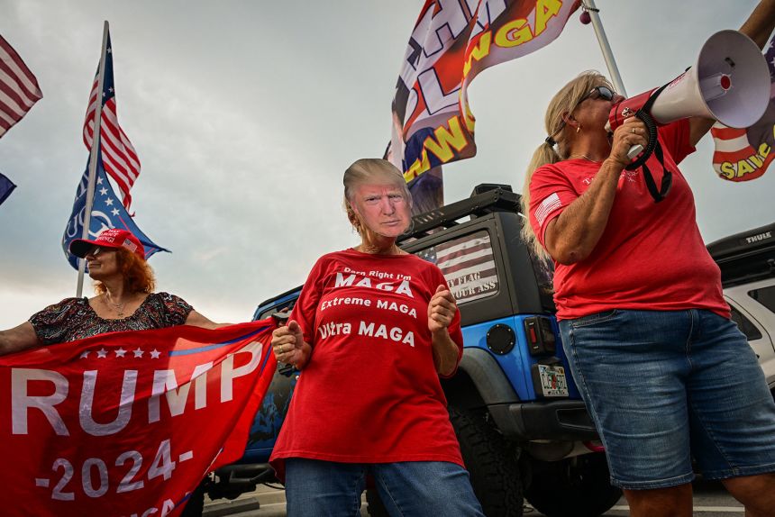 A Trump supporter wears a Trump mask near the Mar-a-Lago residence of President Donald Trump in West Palm Beach, Florida, on July 17.