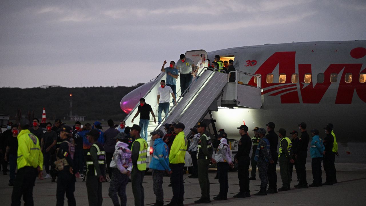 Venezuelan migrants who were jailed in El Salvador get off a plane at Simon Bolivar International Airport in Maiquetia, Venezuela on July 18, 2025.